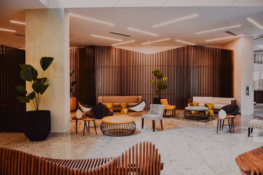 Corporate lobby lounge with a slatted timber feature wall, terrazzo flooring and curated modern seating