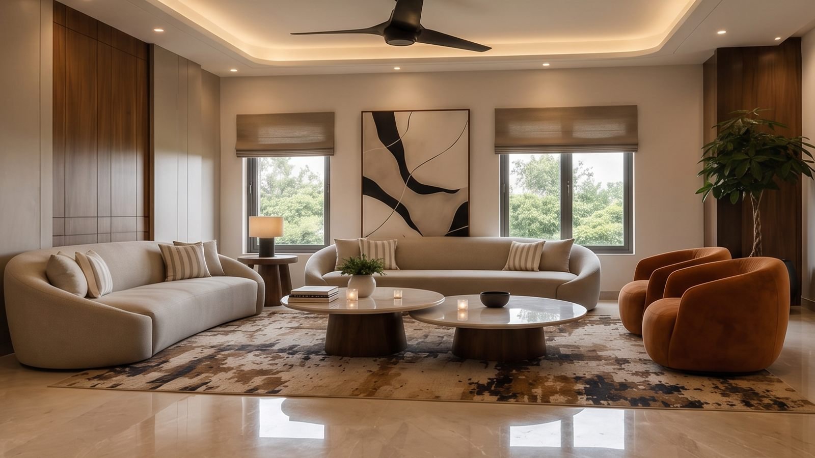 The same living room after renovation by Elite Residencies, with curved sofas, cove lighting and polished marble flooring